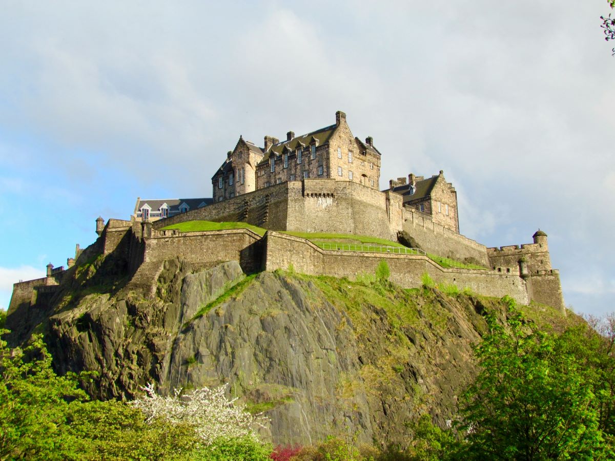 Edinburgh Castle, on top of the hill, on a sunny day.