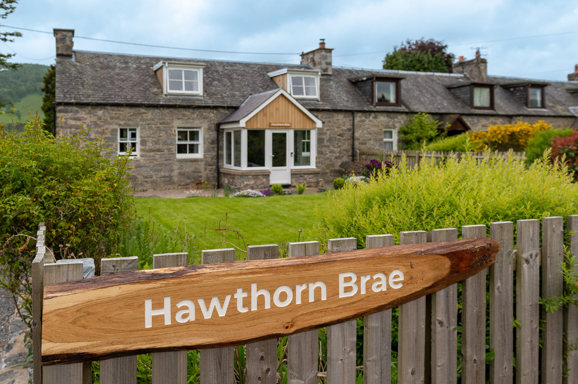 Hawthorn Brae cottage and its front garden.