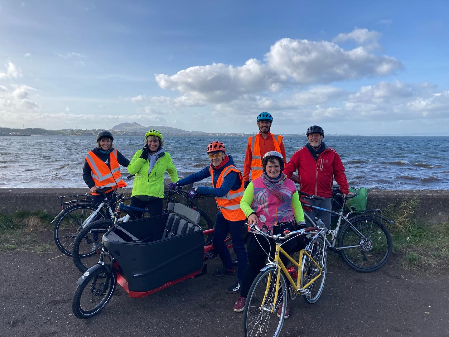 Porty Energy bike librarians with their bikes on the promenade.